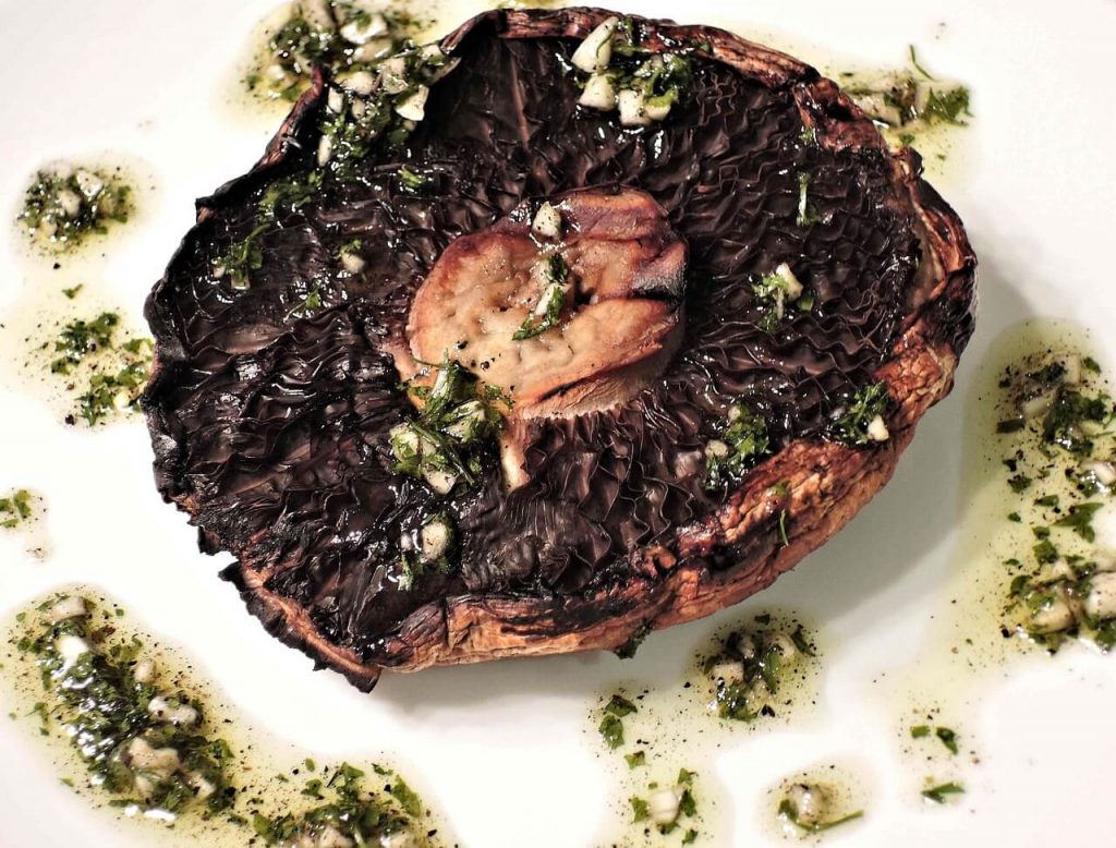 A juicy and flavorful portobello mushroom steak, grilled to perfection and served.